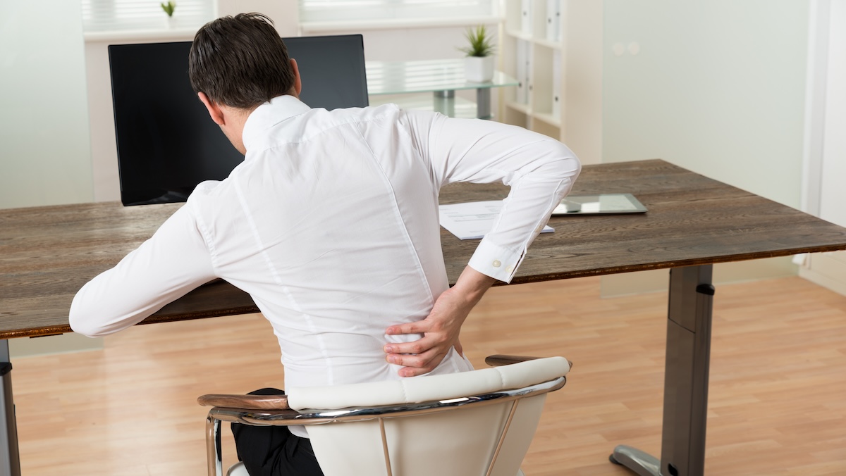 A man having back pain and looking for ergonomic chair with adjustable mechanisms for lower back support